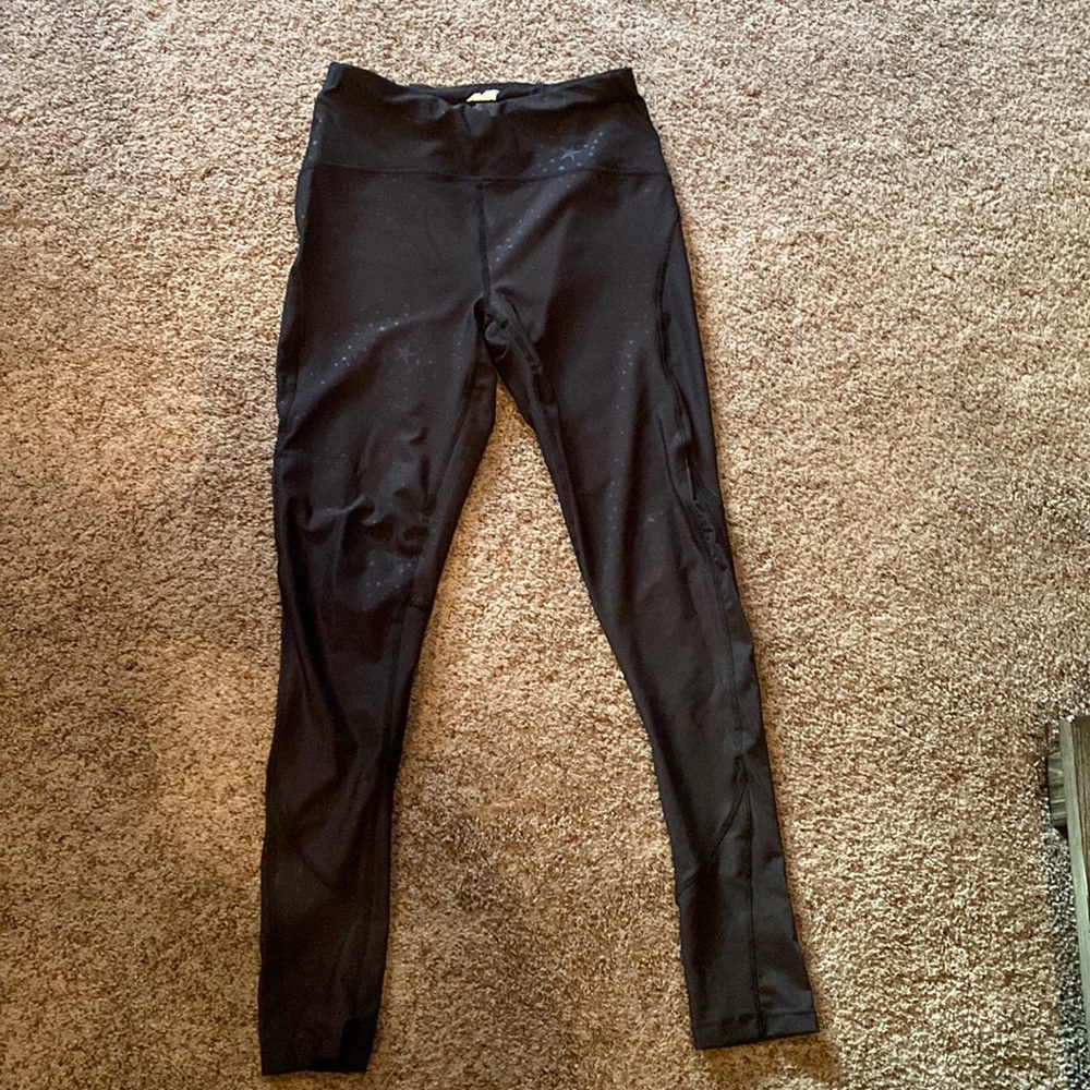Avia black leggings w star embellishments and mesh at ankles to knee on side